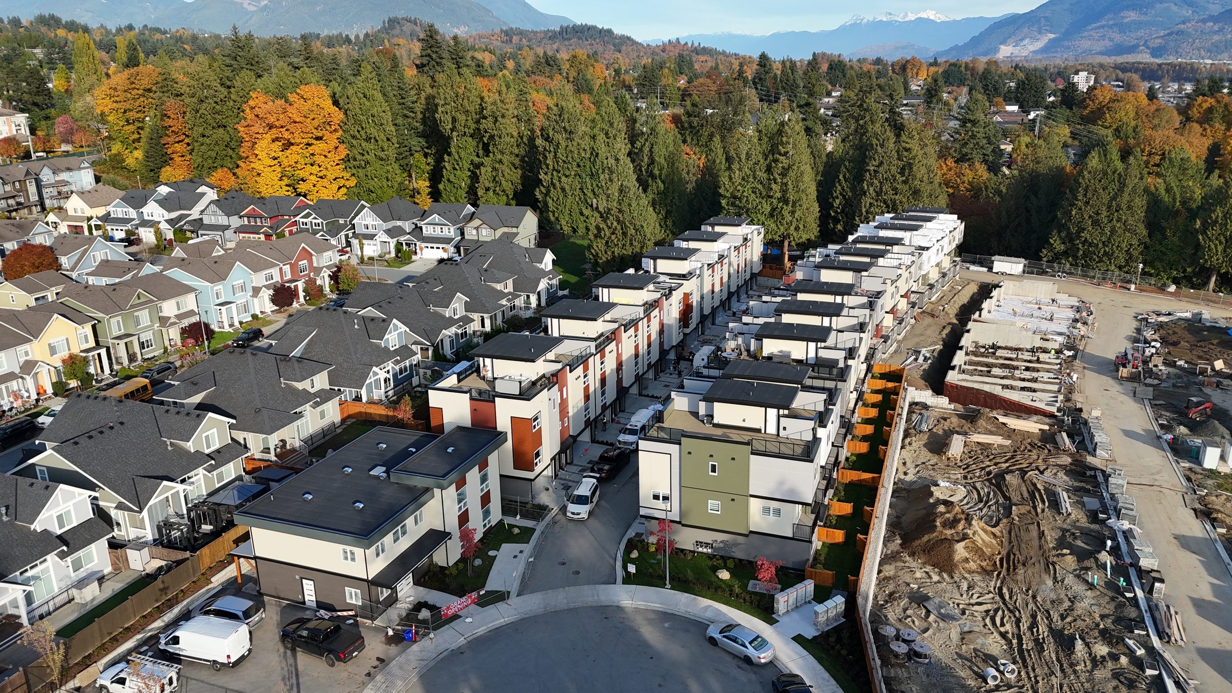 Aerial view of a BC Legacy townhouse development in Metro Vancouver with mountains behind